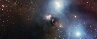 Illustration for article titled A star wrapped in the beautiful colors of the nebula that birthed it